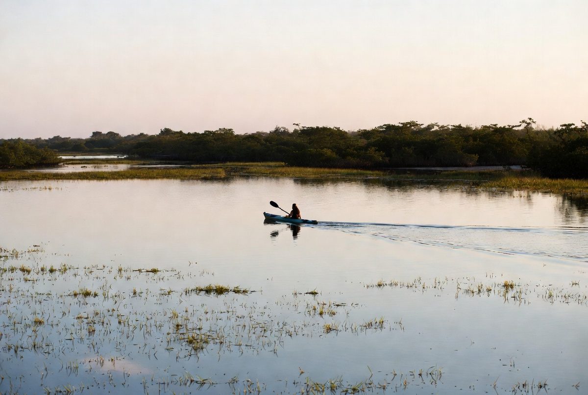 Kayaker on the Laguna Madre at sunset with golden light on the water
